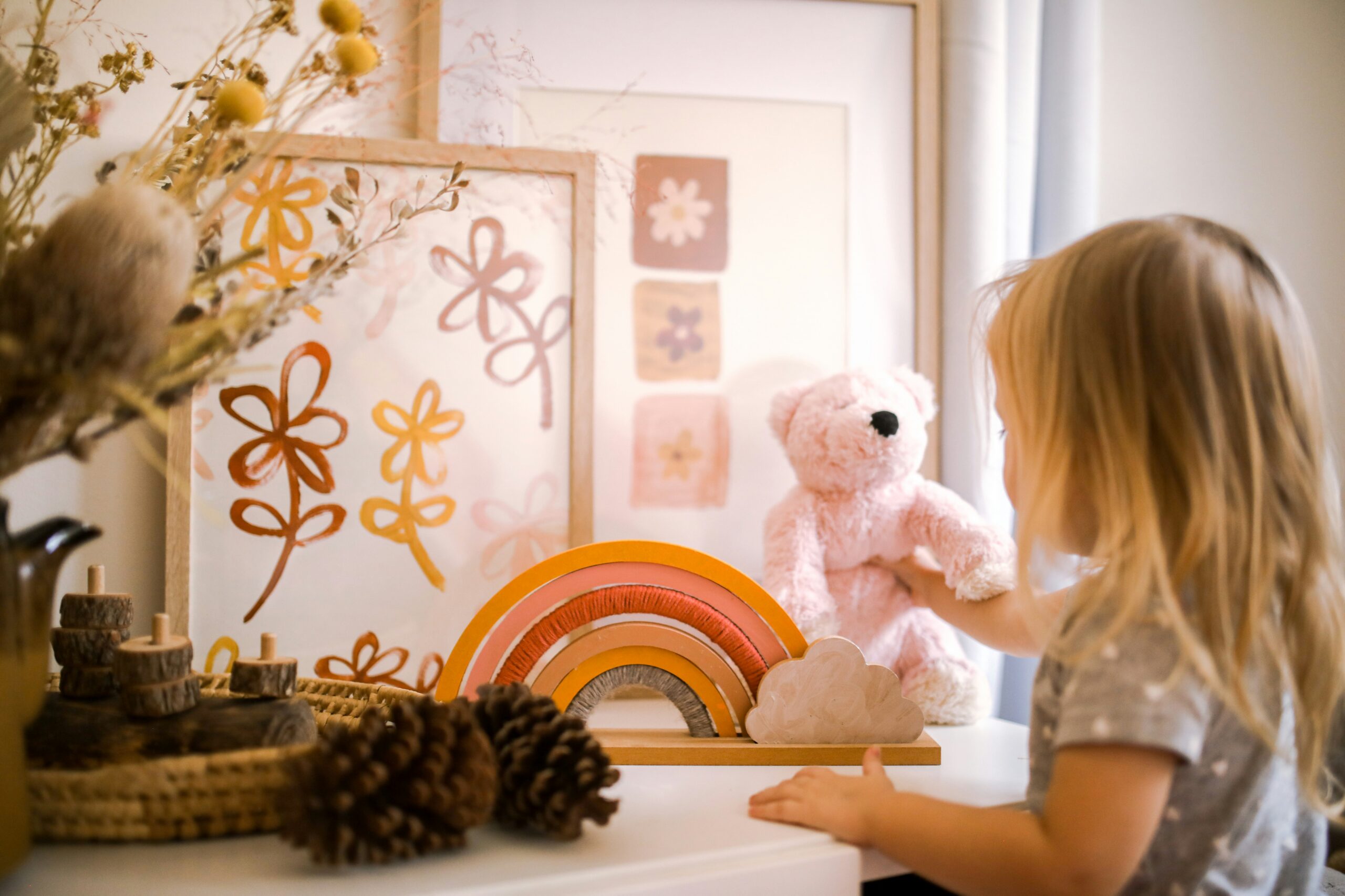 girl-wearing-grey-shirt-standing-near-framed-artwork