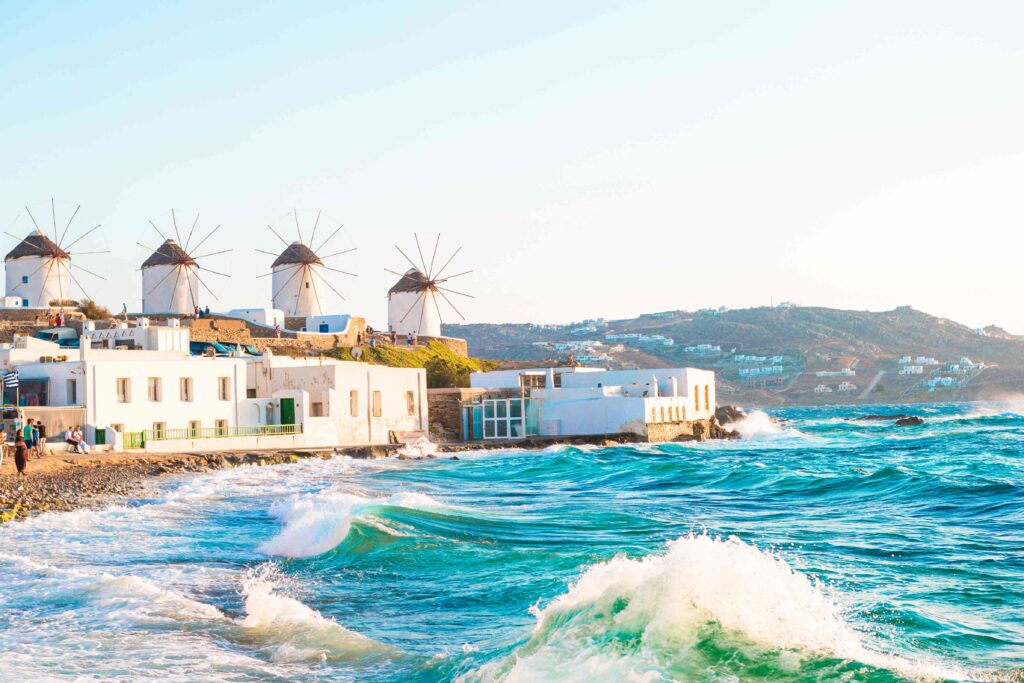 Famous view of traditional greek windmills on Mykonos island at sunrise, Cyclades, Greece