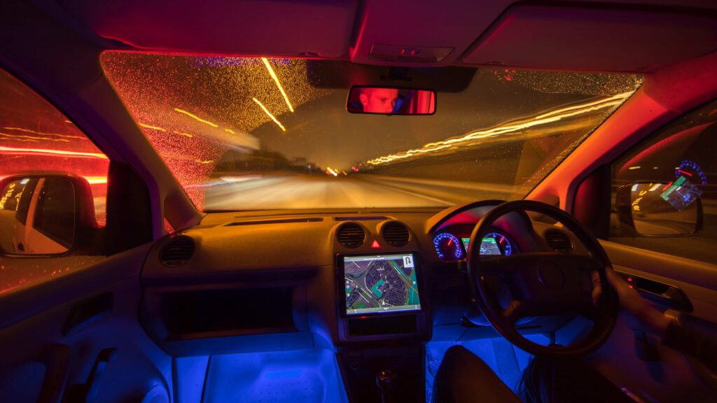 The man drive with a map on a rainy road Evening night time Left side traffic