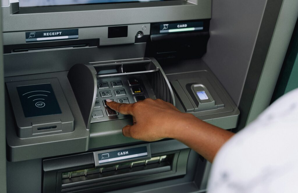 a-person-using-an-atm-machine-to-pay-money