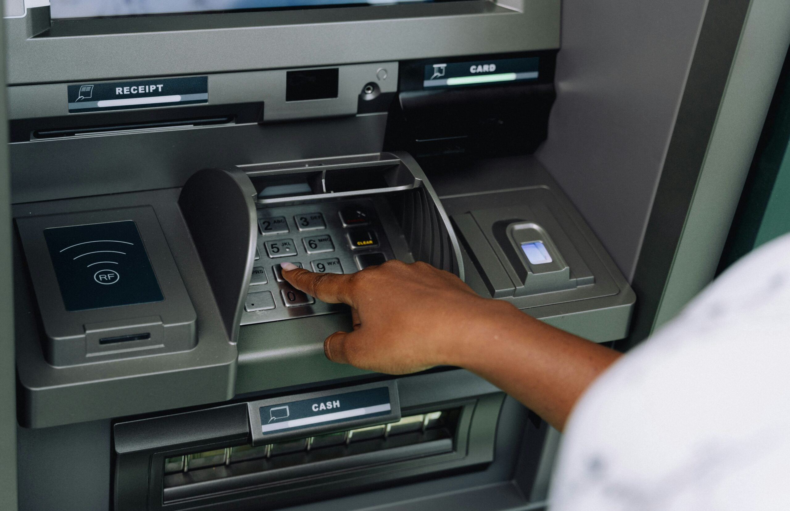 a-person-using-an-atm-machine-to-pay-money