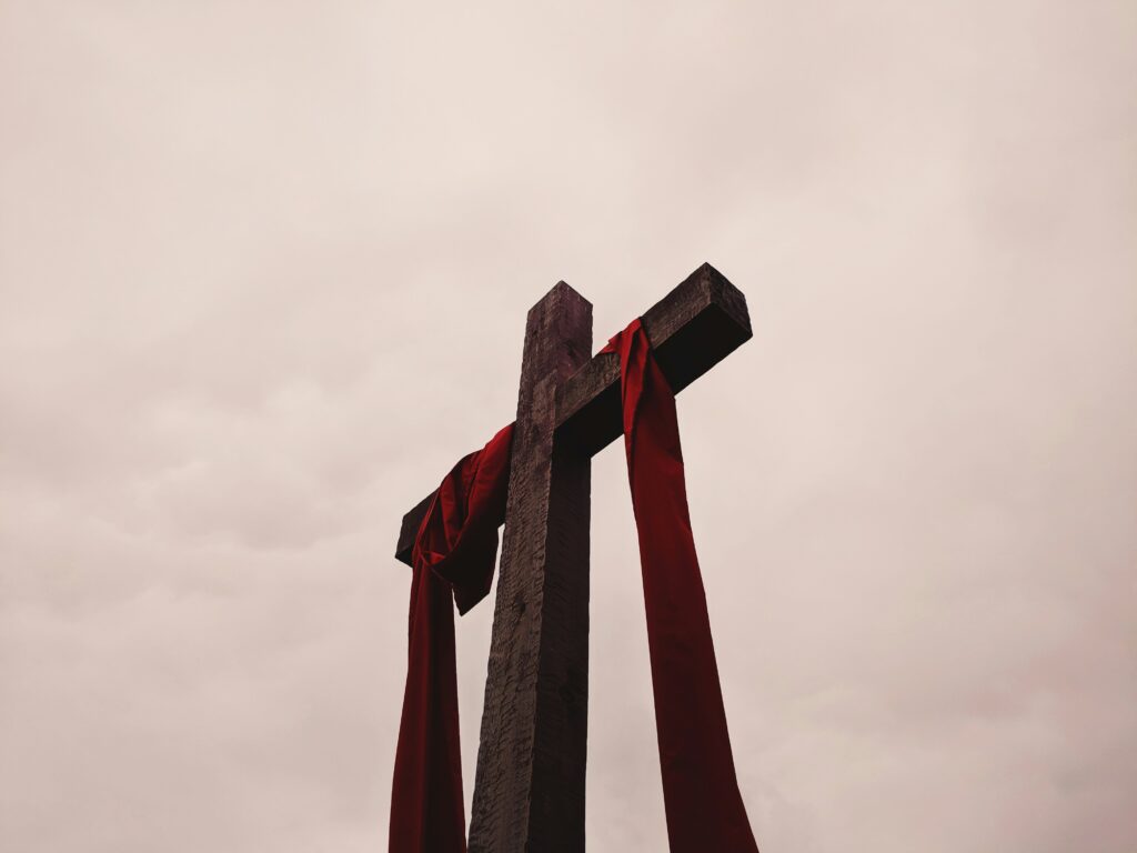 low-angle-view-of-cross-with-red-garment