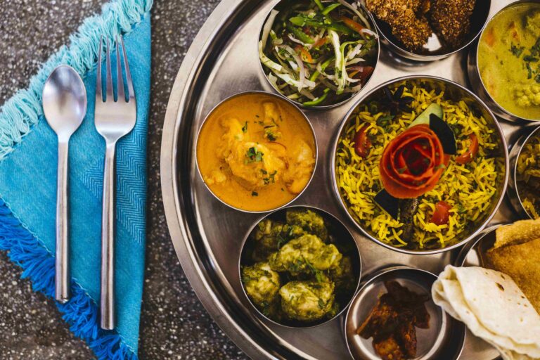 High angle close up of traditional Indian lunch with rice, various curries, pickles, and vegetables ,Goa