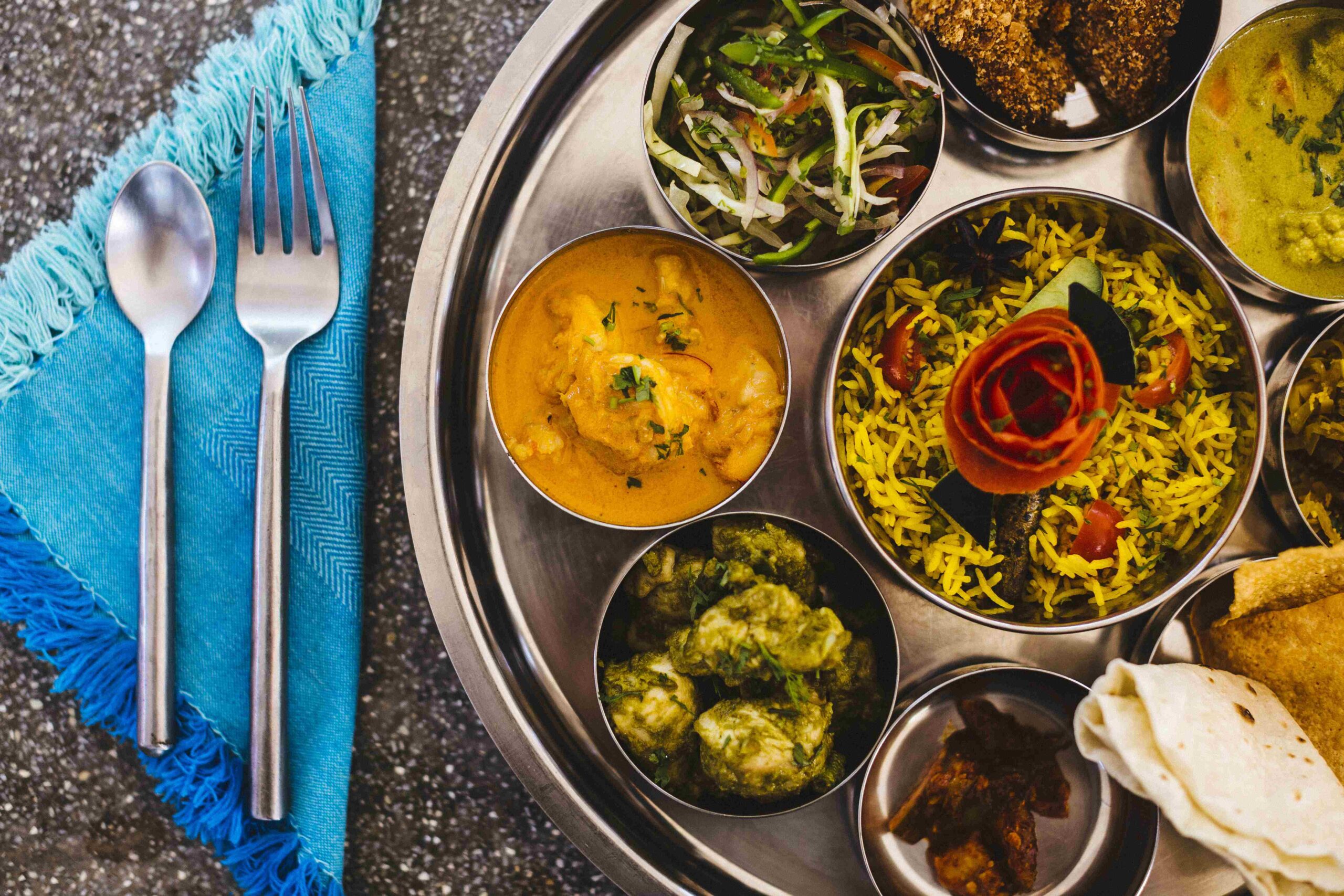 High angle close up of traditional Indian lunch with rice, various curries, pickles, and vegetables ,Goa