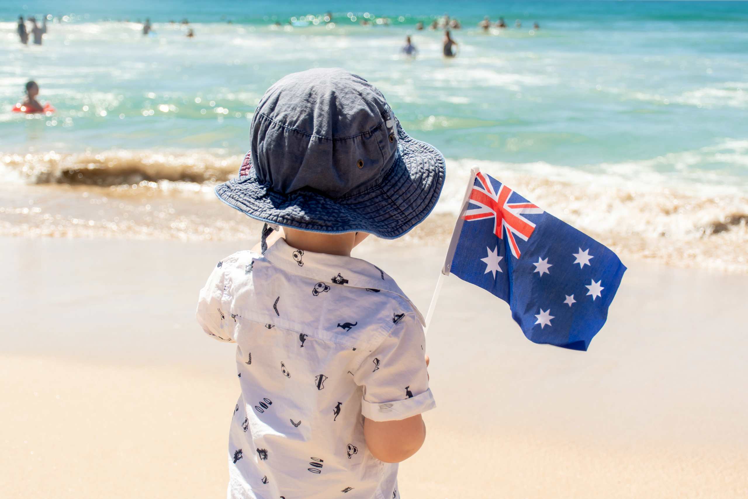 little boy with australian flag near the ocean au 2025 01 08 23 36 51 utc