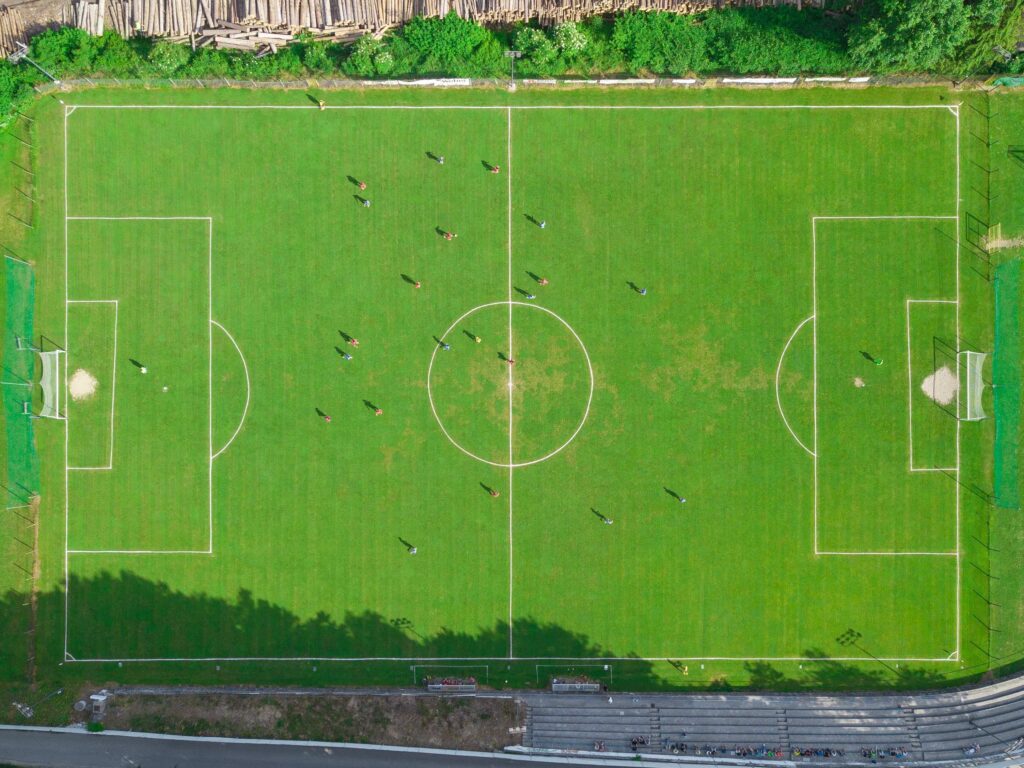Aerial top view of a football field with players