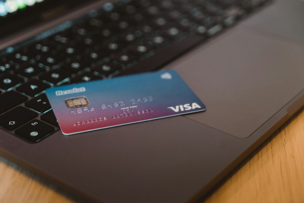 blue-and-white-visa-card-on-silver-laptop-computer