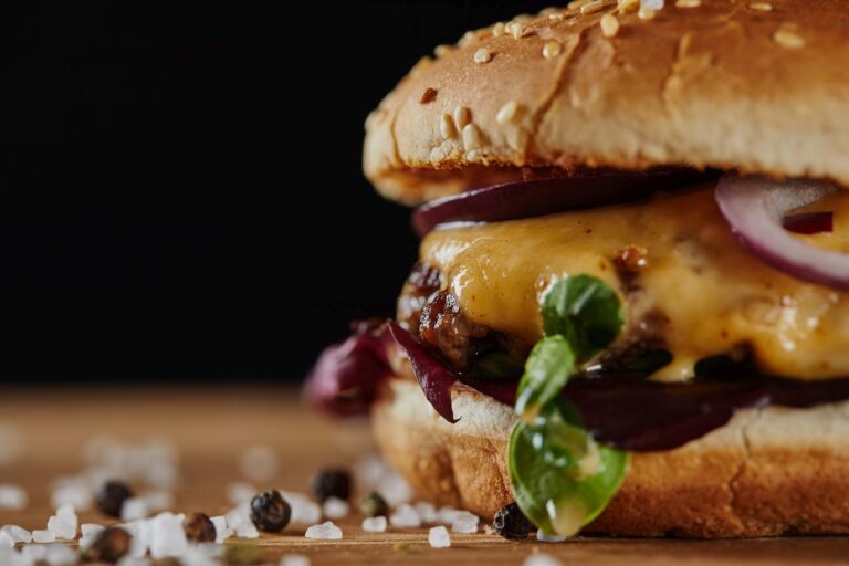 close up of salt and delicious burger with meat, cheese and onions