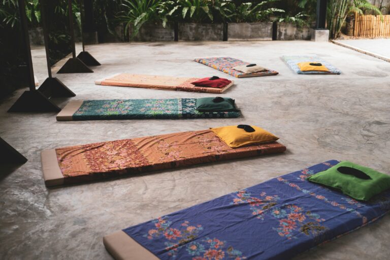 a-group-of-yoga-mats-sitting-on-top-of-a-cement-floor