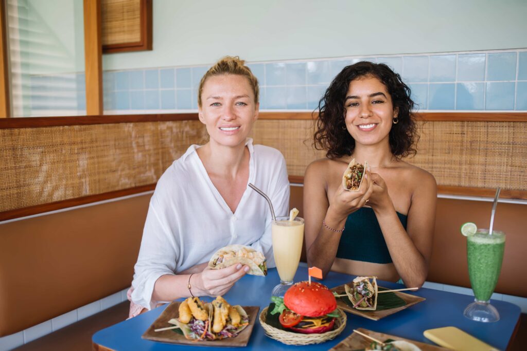 Diverse women having lunch in summer kitchen