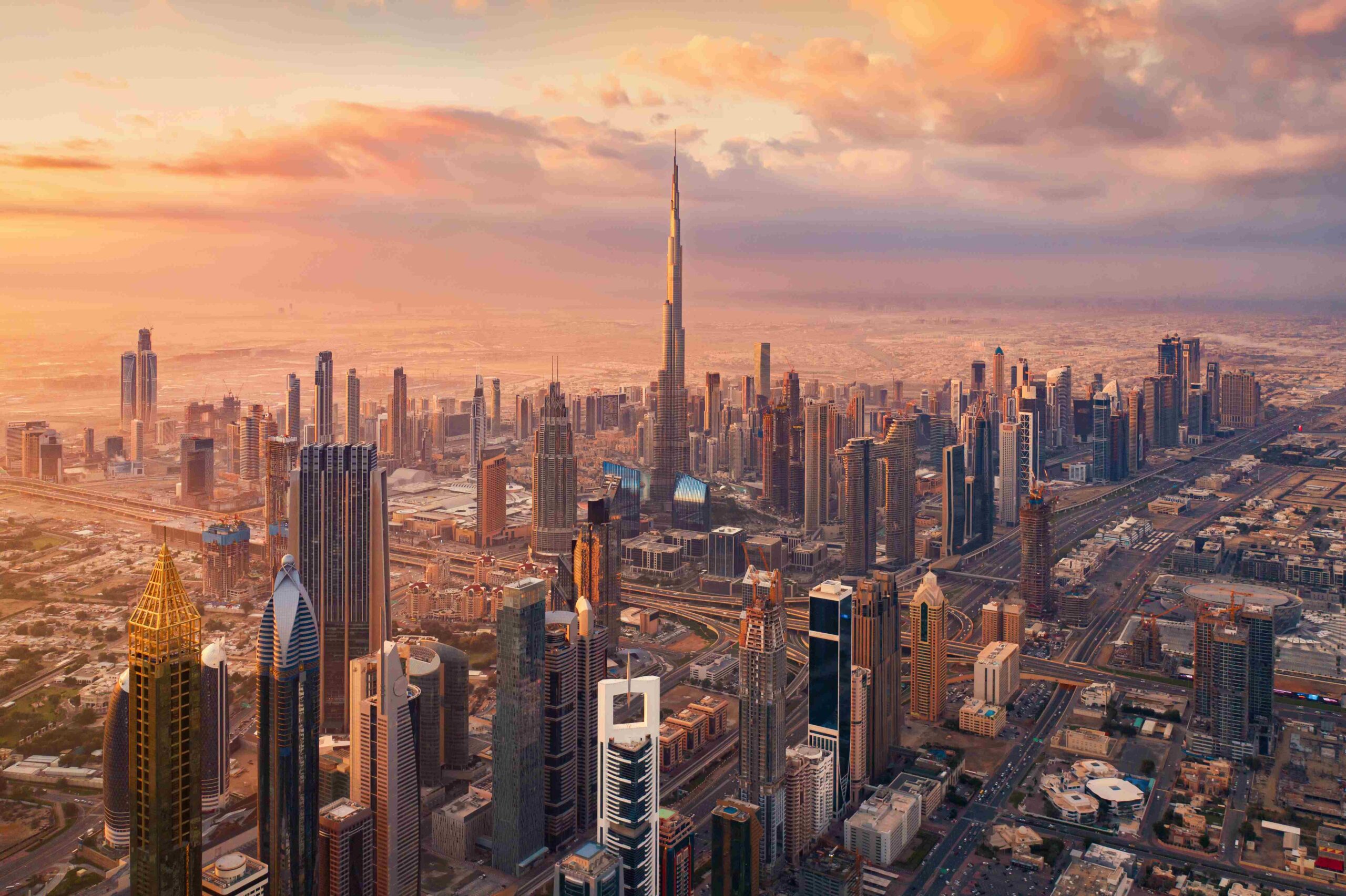 Aerial view of Burj Khalifa in Dubai Downtown skyline and highway, United Arab Emirates or UAE Financial district and business area in smart urban city Skyscraper and high rise buildings at sunset