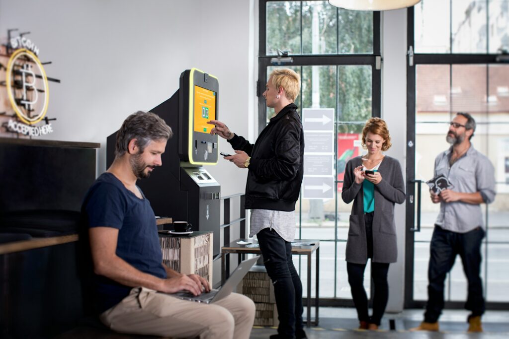 a-group-of-people-standing-around-a-machine