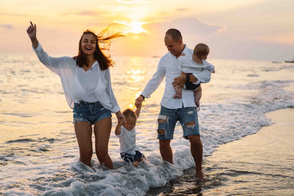 Happy family having fun playing beach in summer vacation on the beach