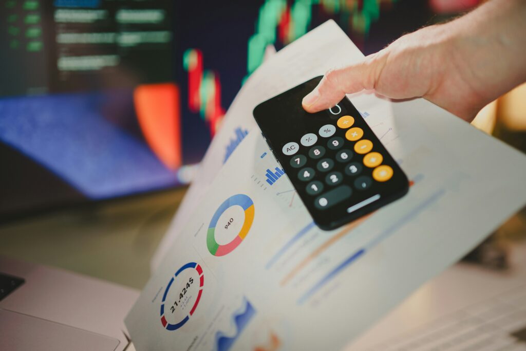 a-person-holding-a-calculator-over-a-piece-of-paper