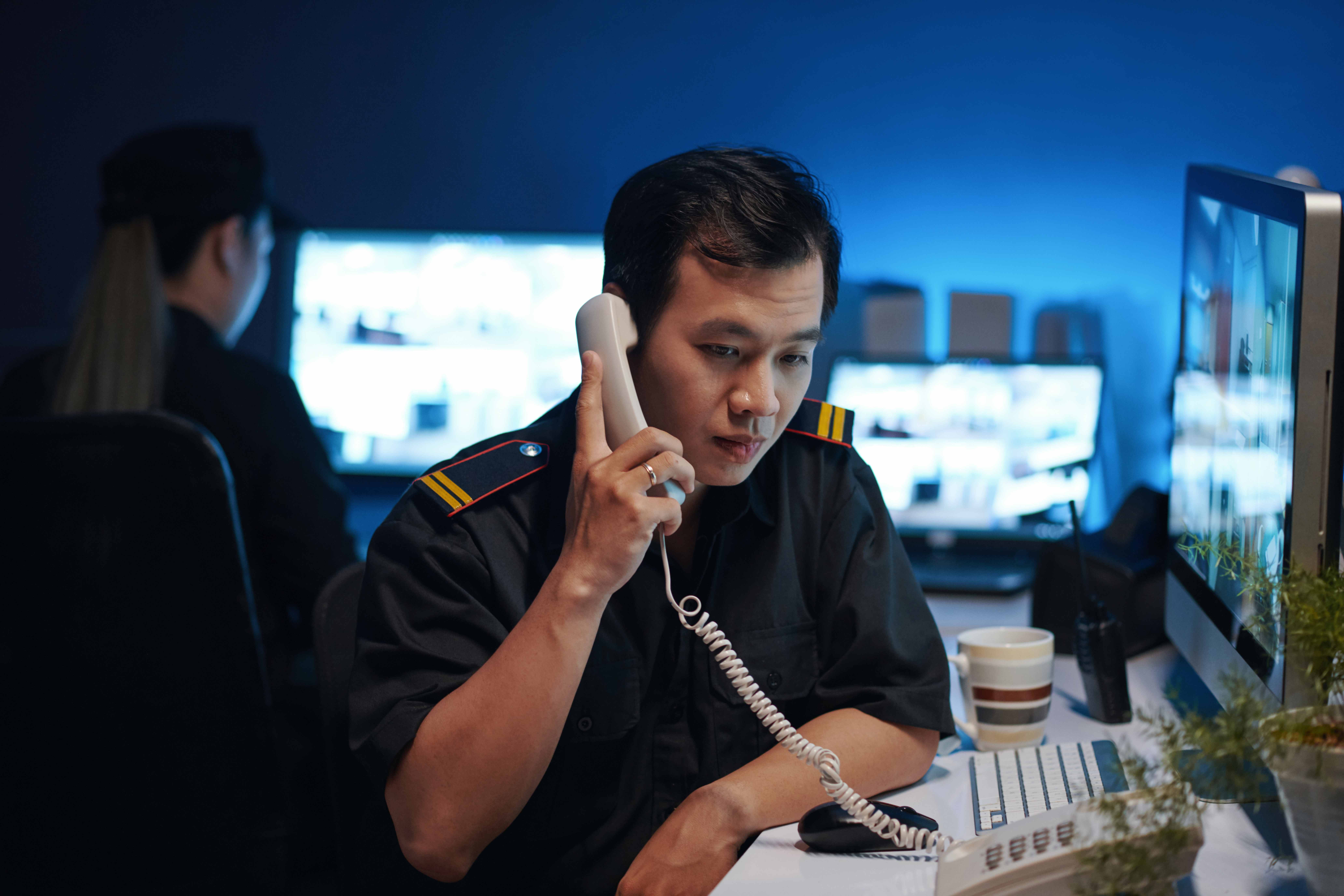 Security Worker Talking By The Phone